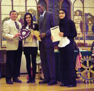President of The Rotary Club of Ascot Colin Corio presents the winning team from Uxbridge College with their prize. The students (L-R) are: (L-R) Muska Nizami (18), Ismaila Ngum (17) and Sabyha Khan (16).